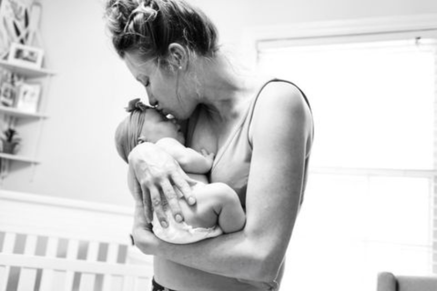 mother holding her baby after a traumatic birth via c section