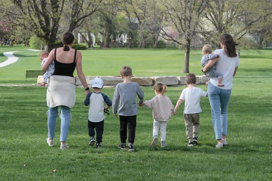 moms walking in park with kids