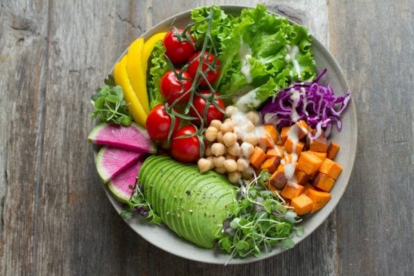 salad with mixed greens, tomatoes, avocado, chickpeas, sweet potato