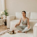 mom practicing self care through meditating