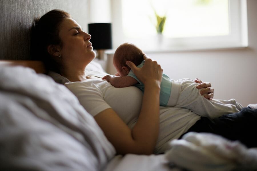 Mom laying with Baby In Postpartum Period