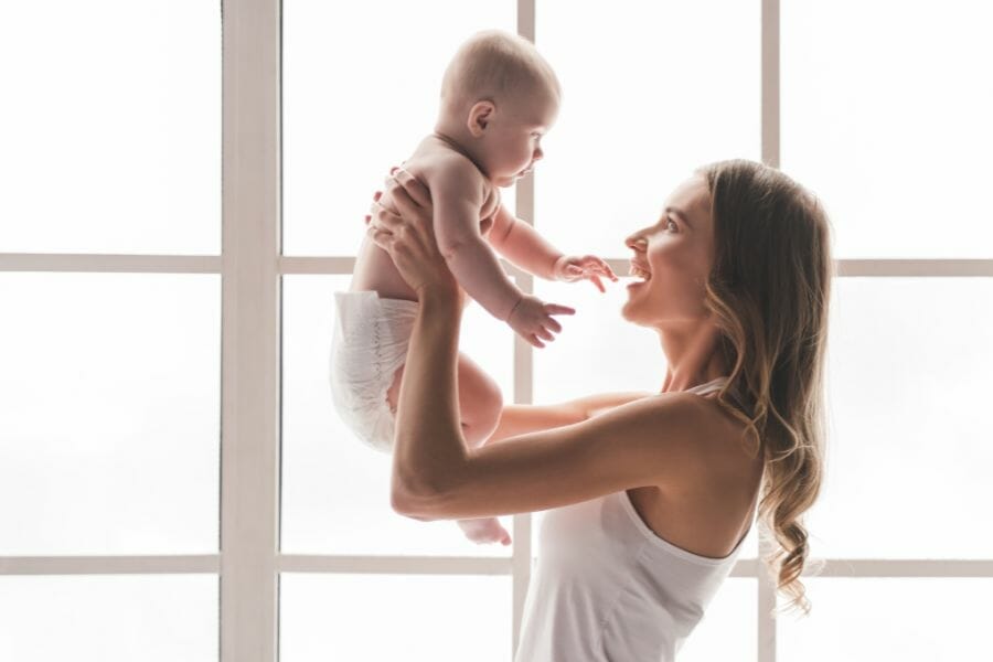 Postpartum mom lifting baby