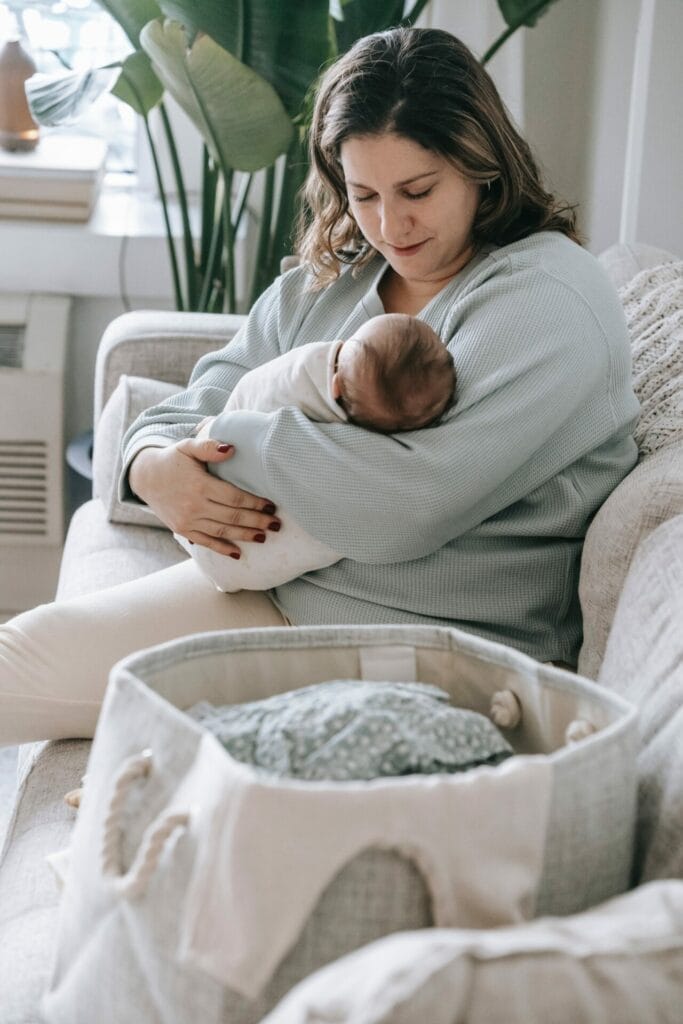 mom holding newborn before returning to work