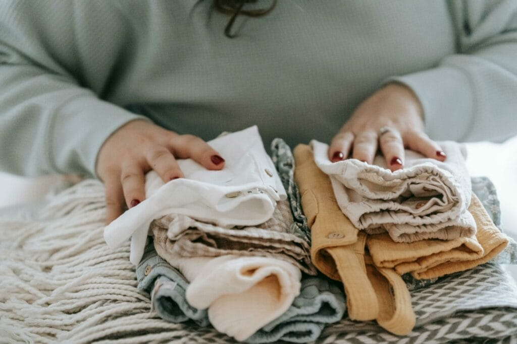 mom folding baby laundry