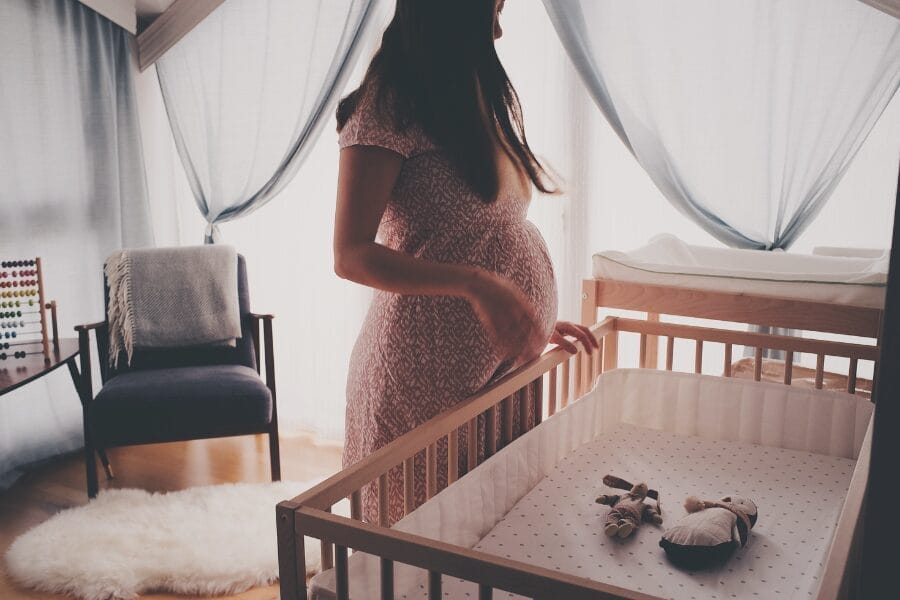 pregnant woman in baby nursery