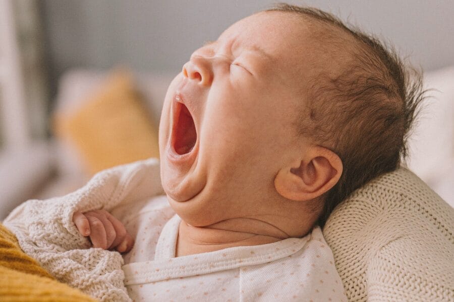 tired baby yawning